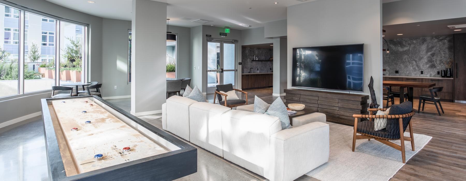 a living room with a large tv and a large glass table