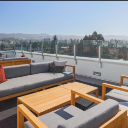 a deck with a view of a city and the ocean