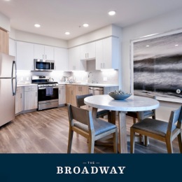 a kitchen with a dining table with chairs